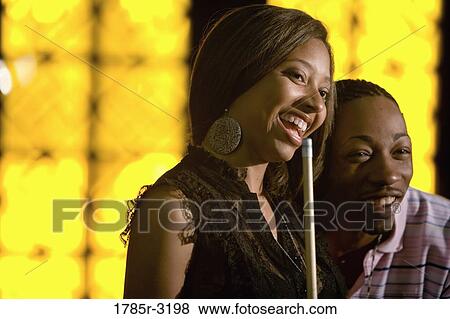 Young couple holding cue stick View Large Photo Image Stock Photo - Young couple holding cue stick. Fotosearch