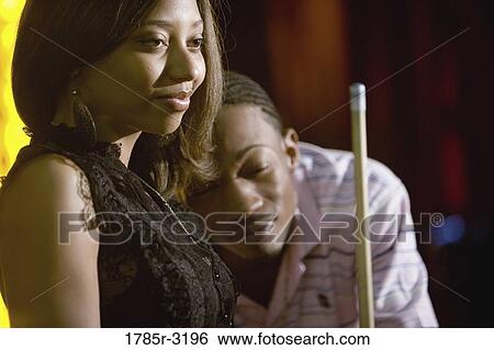 Young couple holding cue stick View Large Photo Image Stock Photograph - Young couple holding cue stick. Fotosearch