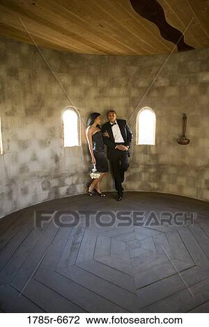 Young couple in formal attire leaning against wall in castle turret View Large Photo Image Stock Image - Young couple in formal attire leaning against wall in castle turret. Fotosearch