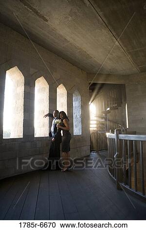 Young couple in formal attire looking out window of medieval castle View Large Photo Image Stock Image - Young couple in formal attire looking out window of medieval castle. Fotosearch