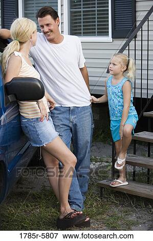 Young couple leaning against old pickup truck with daughter on front steps of house View Large Photo Image Stock Photo - Young couple leaning against old pickup truck with daughter on front steps of house. Fotosearch