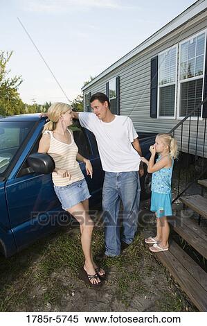 Young couple leaning against old pickup truck with daughter in front of trailer home View Large Photo Image Stock Photography - Young couple leaning against old pickup truck with daughter in front of trailer home. Fotosearch