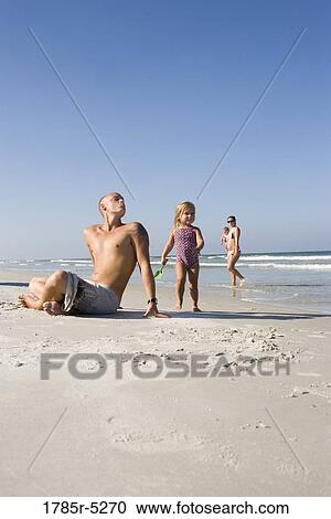 Young family at the beach View Large Photo Image Stock Image - Young family at the beach. Fotosearch