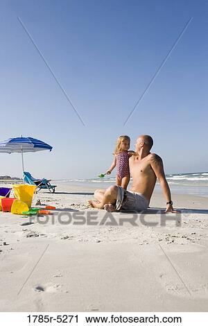 Young family at the beach View Large Photo Image Stock Image - Young family at the beach. Fotosearch