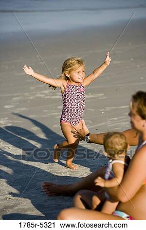 Young family vacationing at the beach View Large Photo Image Stock Image - Young family vacationing at the beach. Fotosearch