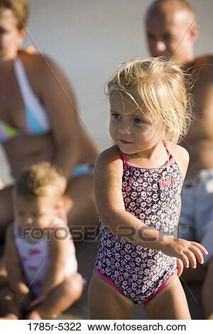 Young family vacationing at the beach View Large Photo Image Stock Image - Young family vacationing at the beach. Fotosearch