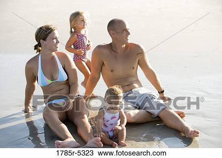 Young family vacationing at the beach View Large Photo Image Stock Image - Young family vacationing at the beach. Fotosearch