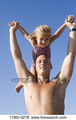 Stock Photo - Young father and daughter playing. Fotosearch