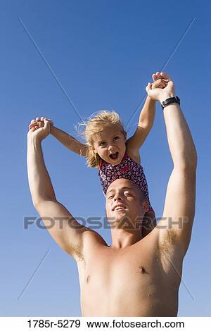 Stock Photo - Young father and daughter playing. Fotosearch