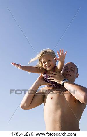 Young father and daughter playing View Large Photo Image Stock Photograph - Young father and daughter playing. Fotosearch