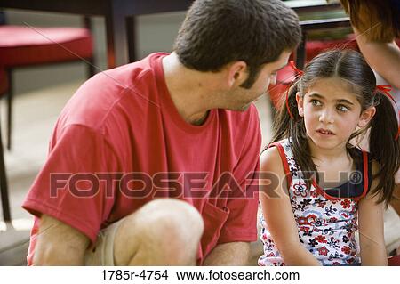 Picture - Young girl conversing with her father. Fotosearch