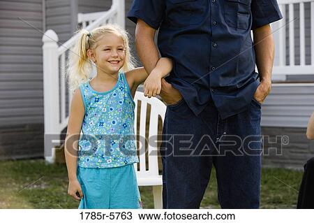Young girl holding her father's arm View Large Photo Image Stock Image - Young girl holding her father's arm. Fotosearch