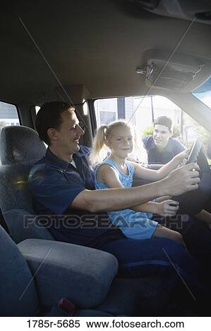 Young girl sitting on father's lap in pickup truck, pretending to drive View Large Photo Image Stock Photography - Young girl sitting on father's lap in pickup truck, pretending to drive. Fotosearch