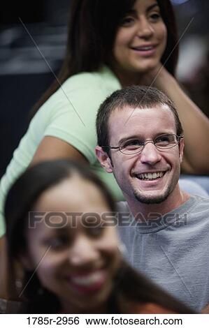 Stock Photograph - Young man and women smiling. Fotosearch