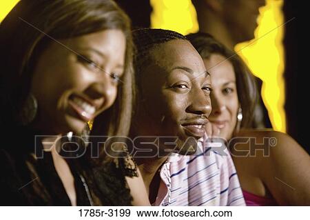 Young man hanging out with two beautiful women View Large Photo Image Stock Photo - Young man hanging out with two beautiful women. Fotosearch
