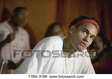 Young man in hip-hop fashion looking up View Large Photo Image Stock Photo - Young man in hip-hop fashion looking up. Fotosearch