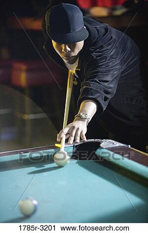 Young man in hip-hop fashion playing pool View Large Photo Image Stock Image - Young man in hip-hop fashion playing pool. Fotosearch