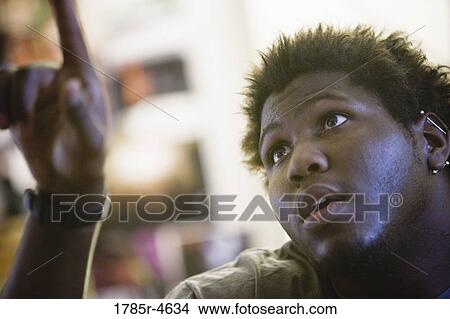 Young man looking up View Large Photo Image Picture - Young man looking up. Fotosearch
