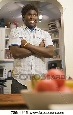 Young man standing with folded hands View Large Photo Image Stock Photography - Young man standing with folded hands. Fotosearch