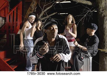Young men and women in hip-hop fashion partying and dancing View Large Photo Image Stock Image - Young men and women in hip-hop fashion partying and dancing. Fotosearch