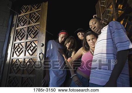 Young men and women in hip-hop fashion at entrance to a bar View Large Photo Image Stock Image - Young men and women in hip-hop fashion at entrance to a bar. Fotosearch