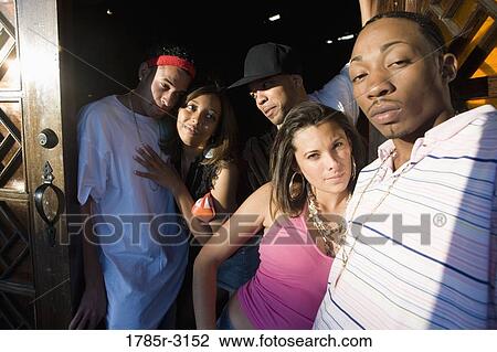 Young men and women in hip-hop fashion at entrance to a bar View Large Photo Image Stock Image - Young men and women in hip-hop fashion at entrance to a bar. Fotosearch
