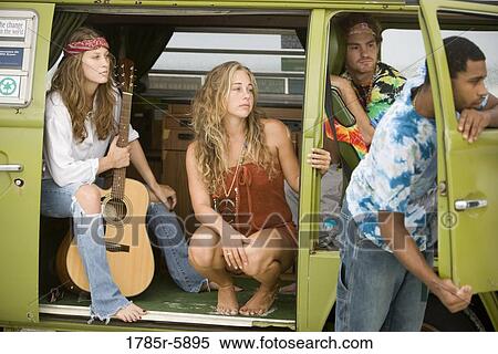Young men and women in hippie fashion sitting in van with guitar View Large Photo Image Stock Photography - Young men and women in hippie fashion sitting in van with guitar. Fotosearch