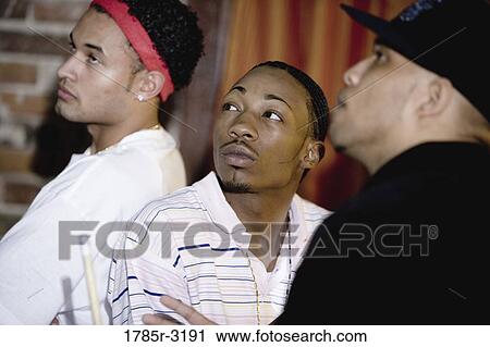 Young men in hip-hop fashion looking up View Large Photo Image Stock Image - Young men in hip-hop fashion looking up. Fotosearch