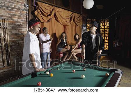Young men in hip-hop fashion shooting billiards View Large Photo Image Stock Photo - Young men in hip-hop fashion shooting billiards. Fotosearch