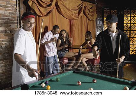 Young men in hip-hop fashion shooting billiards View Large Photo Image Stock Photo - Young men in hip-hop fashion shooting billiards. Fotosearch