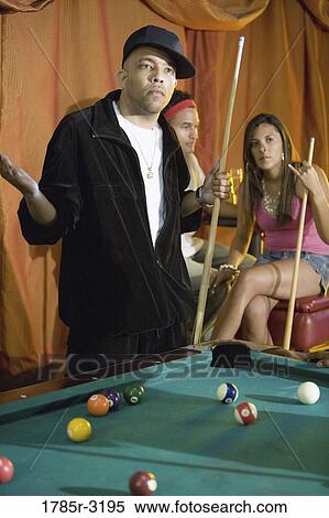 Young people shooting billiards in pool hall View Large Photo Image Stock Photography - Young people shooting billiards in pool hall. Fotosearch