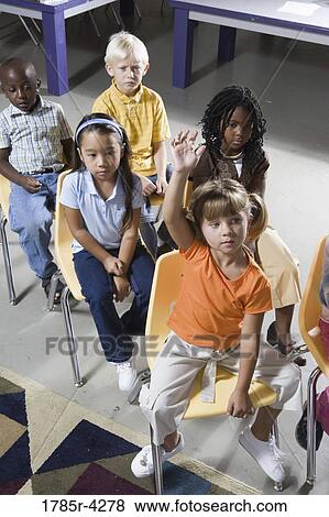 Young students sitting in a classroom View Large Photo Image Stock Photo - Young students sitting in a classroom. Fotosearch