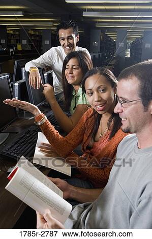 Young students using computers in the library View Large Photo Image Stock Photo - Young students using computers in the library. Fotosearch