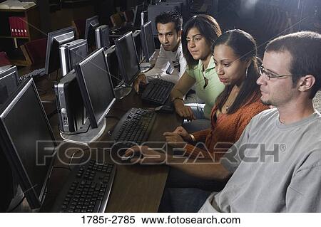 Young students using computers in the library View Large Photo Image Stock Photography - Young students using computers in the library. Fotosearch