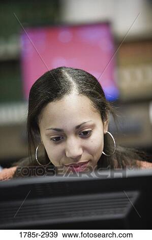 Stock Photo - Young woman using a computer. Fotosearch