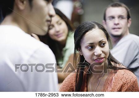 Stock Image - Young woman with friends. Fotosearch