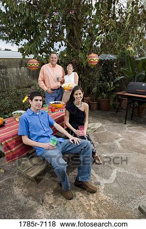 A Mexican-American family enjoying a backyard picnic View Large Photo Image Stock Photo - A Mexican-American family enjoying a backyard picnic. Fotosearch