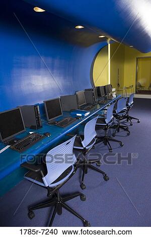 A row of chairs and computer workstations in a vacant classroom View Large Photo Image Stock Image - A row of chairs and computer workstations in a vacant classroom. Fotosearch