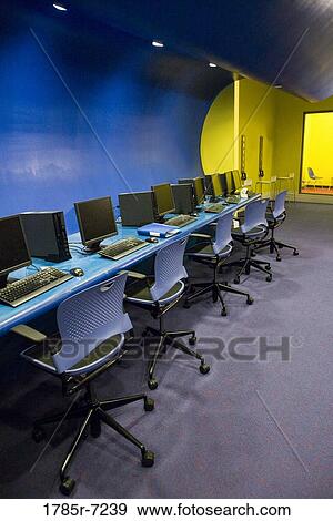 A row of chairs and computer workstations in a vacant classroom View Large Photo Image Stock Photo - A row of chairs and computer workstations in a vacant classroom. Fotosearch