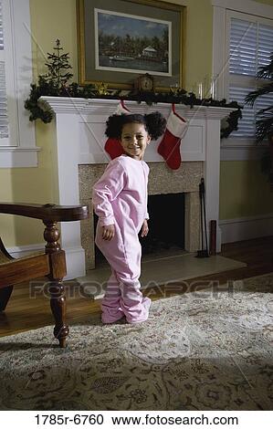 A young girl in pajamas by the fireplace waiting for Santa View Large Photo Image Stock Image - A young girl in pajamas by the fireplace waiting for Santa. Fotosearch