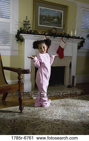 A young girl in pajamas by the fireplace waiting for Santa View Large Photo Image Stock Image - A young girl in pajamas by the fireplace waiting for Santa. Fotosearch