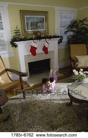 A young girl in pajamas by the fireplace waiting for Santa View Large Photo Image Stock Image - A young girl in pajamas by the fireplace waiting for Santa. Fotosearch
