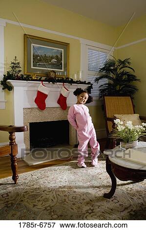 A young girl in pajamas by the fireplace waiting for Santa View Large Photo Image Stock Photo - A young girl in pajamas by the fireplace waiting for Santa. Fotosearch