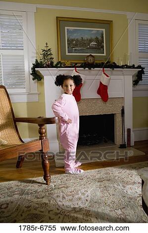 A young girl in pajamas by the fireplace waiting for Santa View Large Photo Image Stock Photography - A young girl in pajamas by the fireplace waiting for Santa. Fotosearch