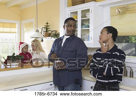 An inter-racial family in the kitchen View Large Photo Image Picture - An inter-racial family in the kitchen. Fotosearch
