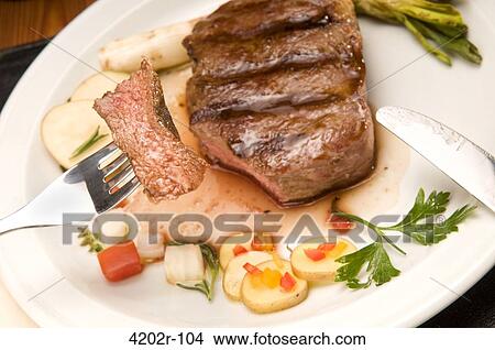 Bife de chorizo served with vegetables View Large Photo Image Picture - Bife de chorizo served with vegetables. Fotosearch