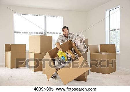 Box falling while man is moving into new house View Large Photo Image Stock Photography - Box falling while man is moving into new house. Fotosearch