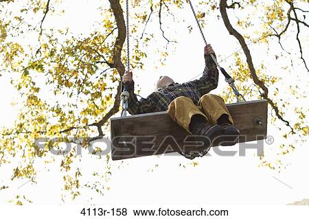 Stock Photo - Boy on swing. Fotosearch