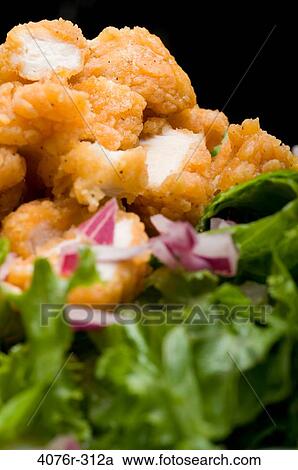 Breaded chicken with onion on lettuce leaves View Large Photo Image Stock Image - Breaded chicken with onion on lettuce leaves. Fotosearch