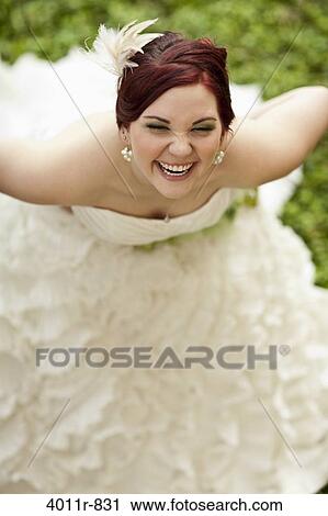 Stock Image - Bride laughing outdoors. Fotosearch